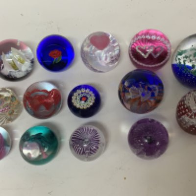 A collection of Caithness and other paperweights.