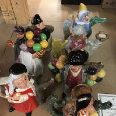 A collection of Eight Doulton Classics tea pots and a ballon seller .