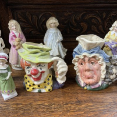 A collection of Royal Doulton ceramics to include figurines, and character jugs, and a large ceramic Magnella design wall plate.