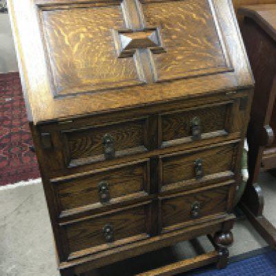 An oak bureau with a rectangular fall front with a fitted interior above three drawers. Width 61cm. NO RESERVE