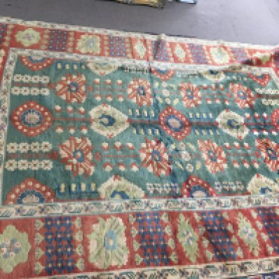 A large hand knot rug with vibrant colours and a geometric pattern. Approx 310cm by 215cm