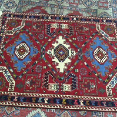 A hand knotted rug. Approximately 220cm by 155cm