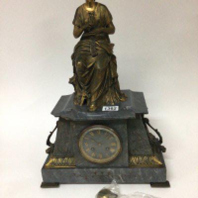 A French late 19th century gilt bronze and marble mantel clock the top surrounded with a seated neo classical female the marble case with further gilt metal embellishments. damage to the corner of the marble case with key and pendulum. Height 54cm
