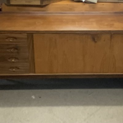 A 1970s Mid Century teak sideboard with Maple label to the door. 229cm x 51cm x 79cm
