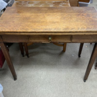 An Antique oak folding kitchen table with single draw.
