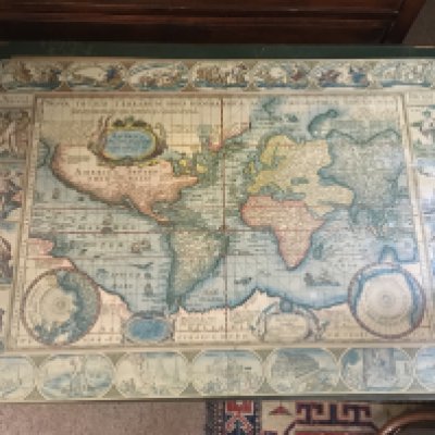 A reproduction table top with a world map on top.