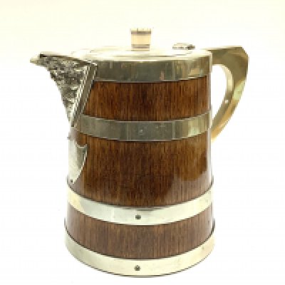 A Mappin and Webb antique oak and silvered brass water pitcher. 24cm.