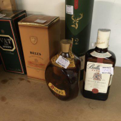 A collection of five bottles of whisky including glenfiddich .