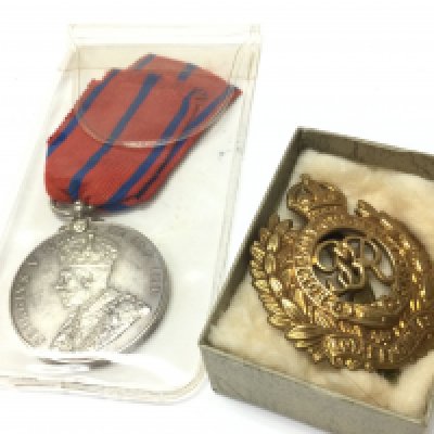 A royal engineers cap badge and a 1911 Metropolitan Police Coronation 1911 medal . Postage category A