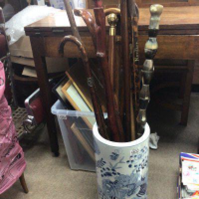 A collection of walking sticks including a horn walking stick in a 20th Century Chinese blue and white e port porcelain stick stand.