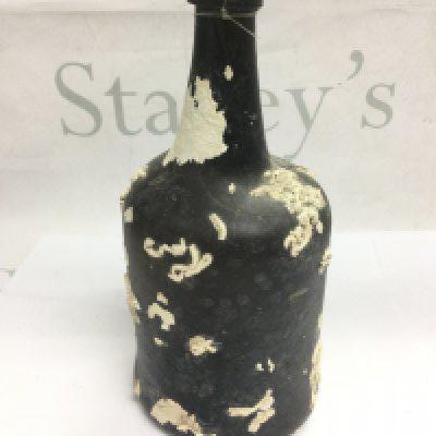 An early 18th or late 17th Century West Country wine bottle, a shipwreck find. Shipping category D.
