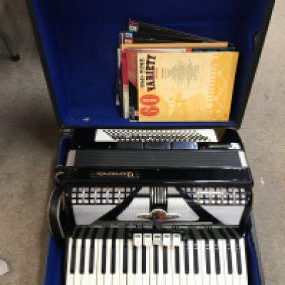 A cased accordion Baecorole, Prominent 120. Base 5 +3 with a black finish in good condition