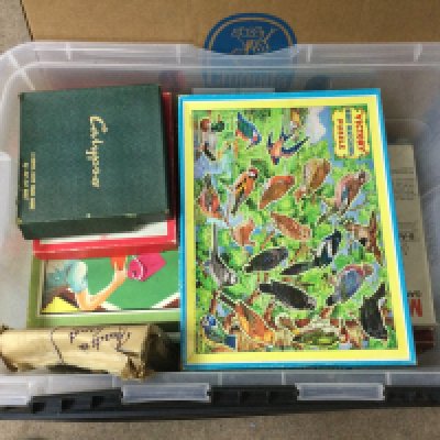 A box of various vintage board games.