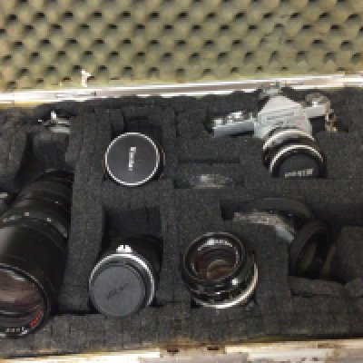 A Nikkormat camera and other Nikon telescopic lens and others in a fitted case.