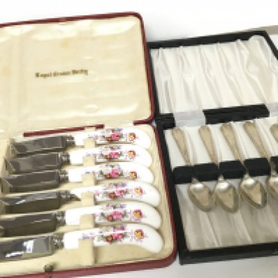 A cased set of silver spoons and a cased set of Royal crown Derby porcelain handled butter knifes. NO RESERVE