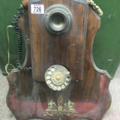 A wall mounted telephone with applied mounts .