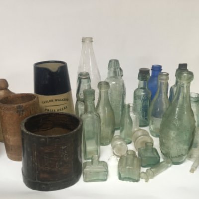 A collection of Victorian and antique glass and stoneware bottles a Taylor Walker advertising stoneware beer jug two Victorian treen wood messers a quart and one other stamped VR 185 Essex 11 PINT.