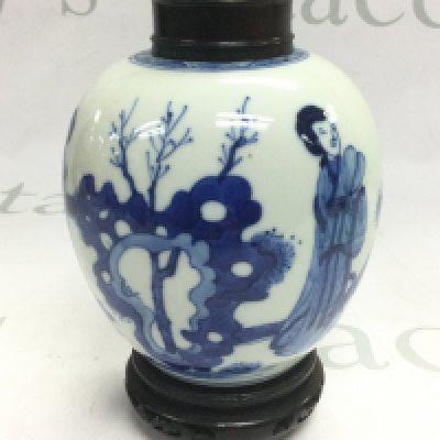 A blue and white ginger jar with a carved wooden lid and stand, approx height 17cm. Shipping category D.