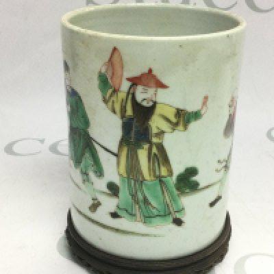 An Oriental brush pot with handpainted decoration of various figures, raised on a hardwood base, approx height 14.5cm. Shipping category D.