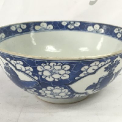 A 19th century Chinese blue and white bowl with a four character mark at the base, 18cm wide. Hairline crack seen and damage. This lot cannot be posted