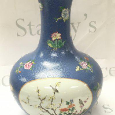A Chinese Qianlong marked vase with hand painted panel design of birds and flowers. No obvious damage or restoration, some flaws in the glaze. 35cm tall. This lot cannot be posted