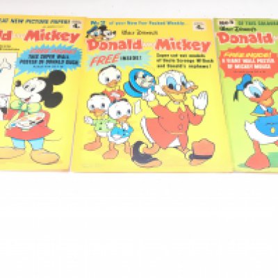A Box Containing Walt Disney Donald And Mickey Comics. The First 3 Walt Disney Donald And Mickey Comics Come With the Gifts. #s 1 And 2 of Donald Duck Comics. Approximately 250 Comics From the early 1970s.No Reserve.