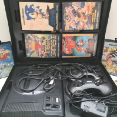 A Sega Mega Drive With Games in a Carry Case.