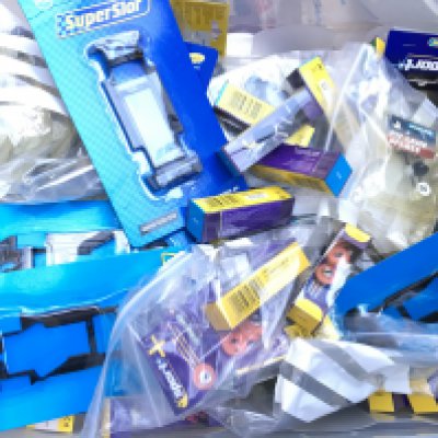 A Box Containing a Collection of New Scalextric Spare Parts.