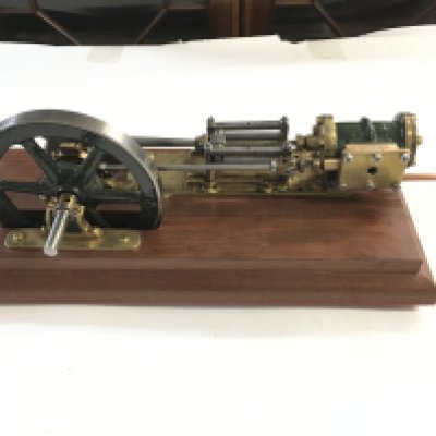 A Horizontal Steam Engine On A Wooden Plinth. Approx length 40Cm. Height 16Cm.