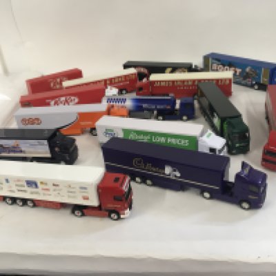 A collection of 12 unboxed model commercial vehicles with trailers. Mostly Corgi. No reserve.