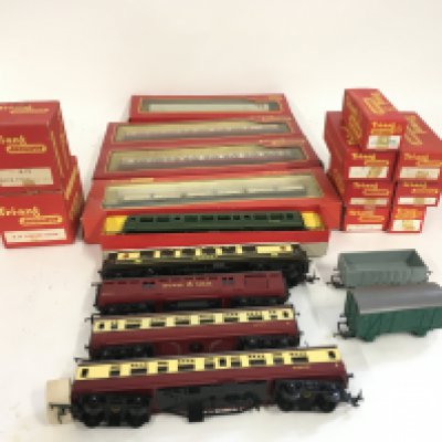 A collection of boxed and loose 00 gauge model railway coaches and wagons by Triang. No reserve
