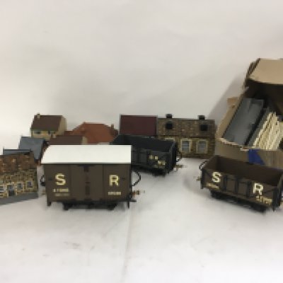 A selection of plastic model buildings for a railway or village scene some assembled. Also 3 x 0 gauge model railway wagons. No reserve