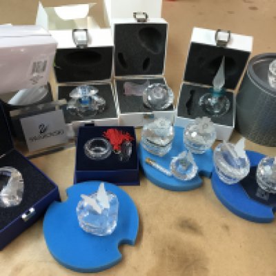 A collection of boxed Swarovski trinket boxes and perfume bottles of various design together with a boxed Swarovski heart