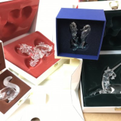 Four boxed Swarovski figures including Pearl Dragon, Unicorn, large squirrel and seahorses