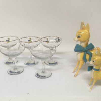 A collection of Vintage Babycham glasses and two figures.