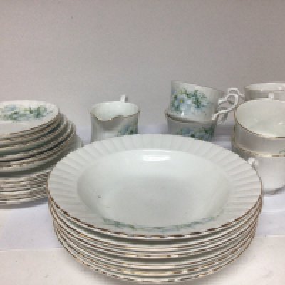 A royal Stafford bone china tea set decorated with flowers on a white glazed ground six place setting with a set of soup bowls no obvious damage.