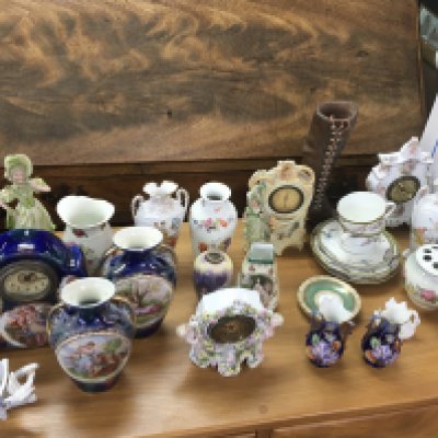 A collection of various ceramics items. 
Postage D