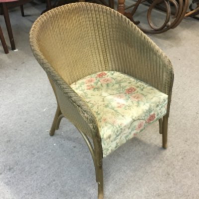 A loom chair with floral upholstery , 70cm tall.