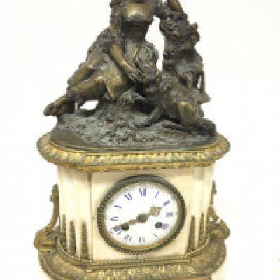 A Quality late 19th Century French clock the top with a bronze figure of a young girl with a dog the marble case embellished with gilt metal mounts the brass movement striking on a bell with key and pendulum not seen working two gilt feet loose. Height 46cm.m
