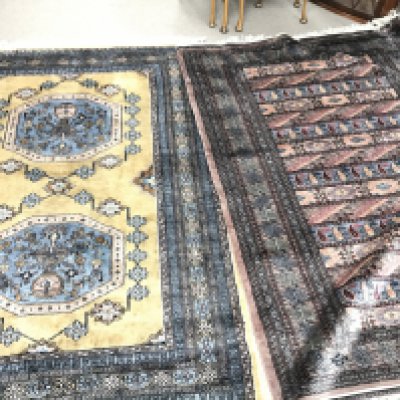 Two large 20th century hand tied wool rugs one with an unusual horizontal repeating pattern. Both pros 190cm long by 130cm wide.