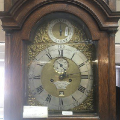 An oak longcase clock the brass dial with silvered chapter ring maker Sam Cannon London eight day going with pendulum and weights.
