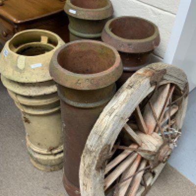 4 Vintage terracotta chimney pots together with a wagon wheel. (D).