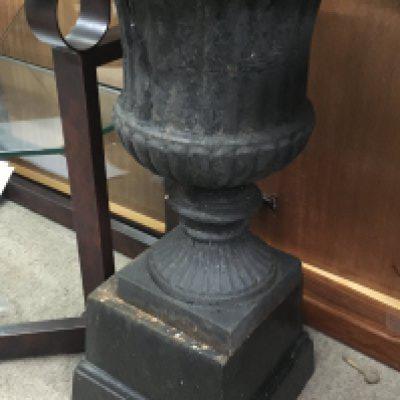 A harder urn of classical form on a stepped base .