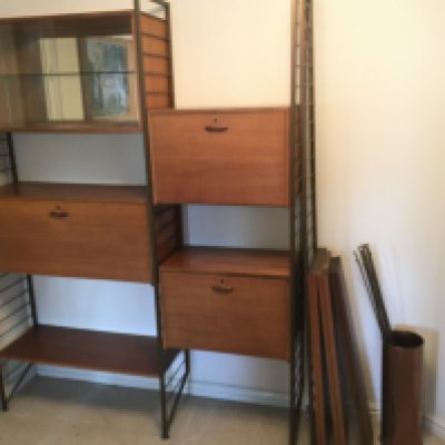 A mid 20th Century Modern design sectional Teak and metal Staples Laderex unit with enclosed sections and open glazed sections.