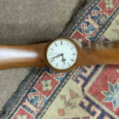 A carved propeller wall clock. (Battery movement clock), (D).