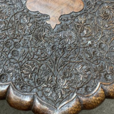 A carved eastern folding table. (D)