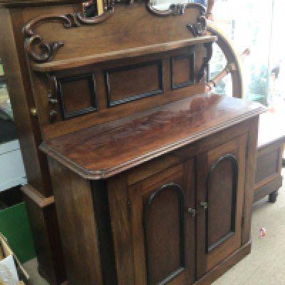 A Victorian walnut chiffonier with a raised back and applied scroll mouldings above cupboards. Width 94cm height 142cm