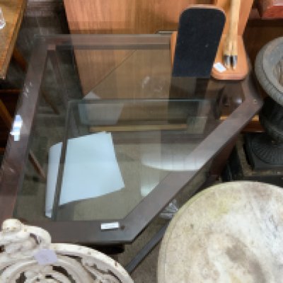 A modern metal and glass corner stand.