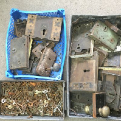 A collection of vintage door locks and assorted keys.