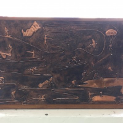 A large copper picture showing a number of sporting activities titled to hole in one. artists name is Richard Dent